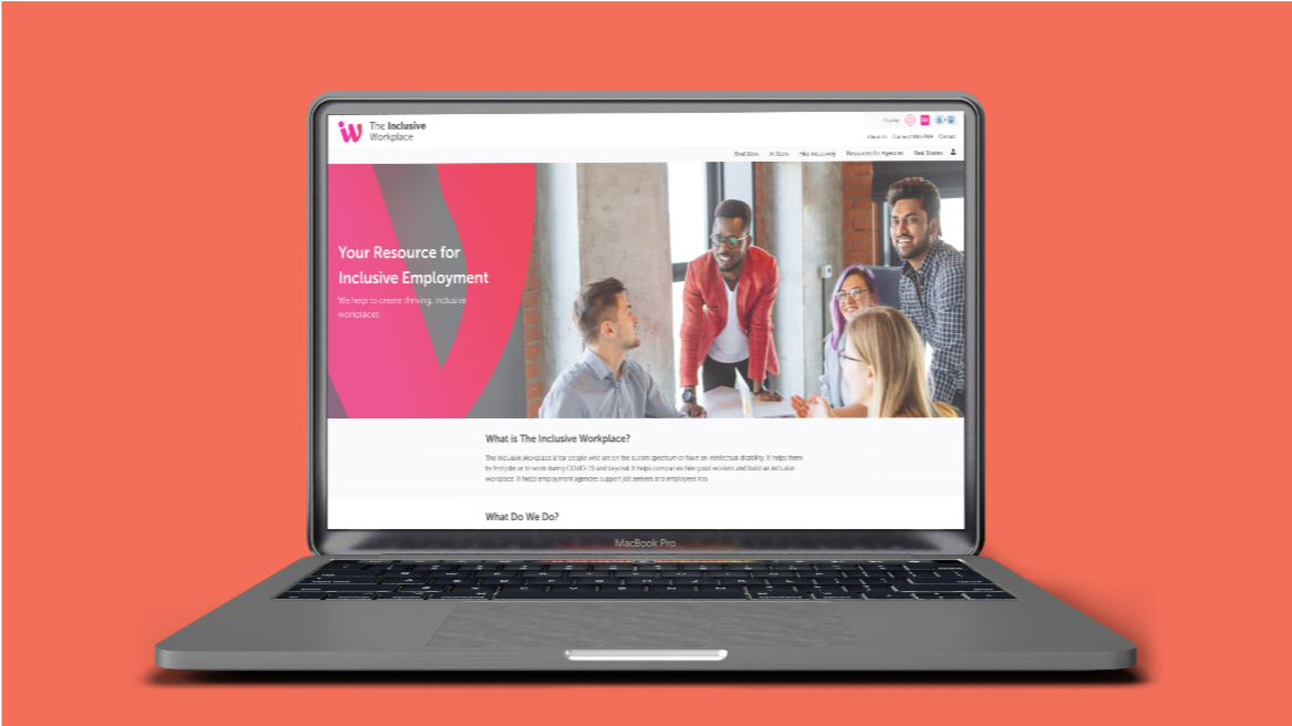 On a salmon pink background, a laptop is open facing outward. On the screen is The Inclusive Workplace website. The text says, 